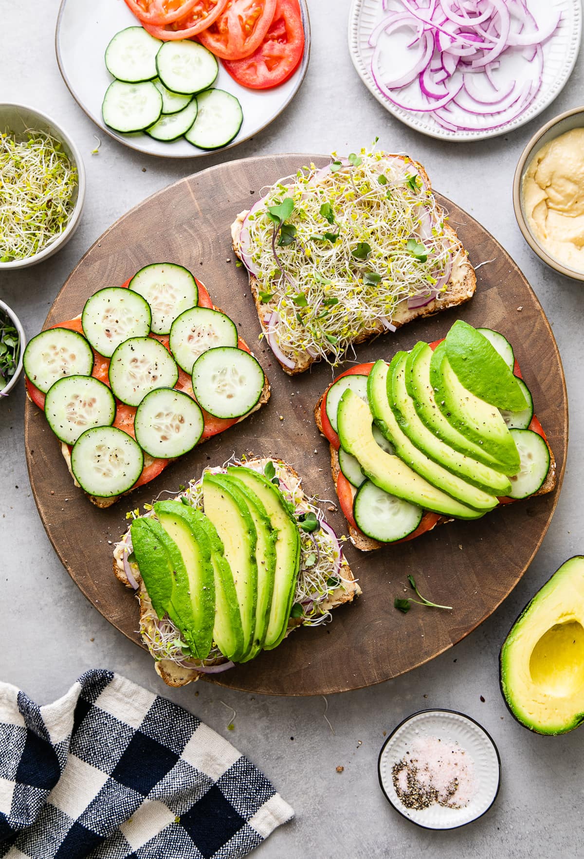 top down view showing the process of making the best hummus veggie sandwich.