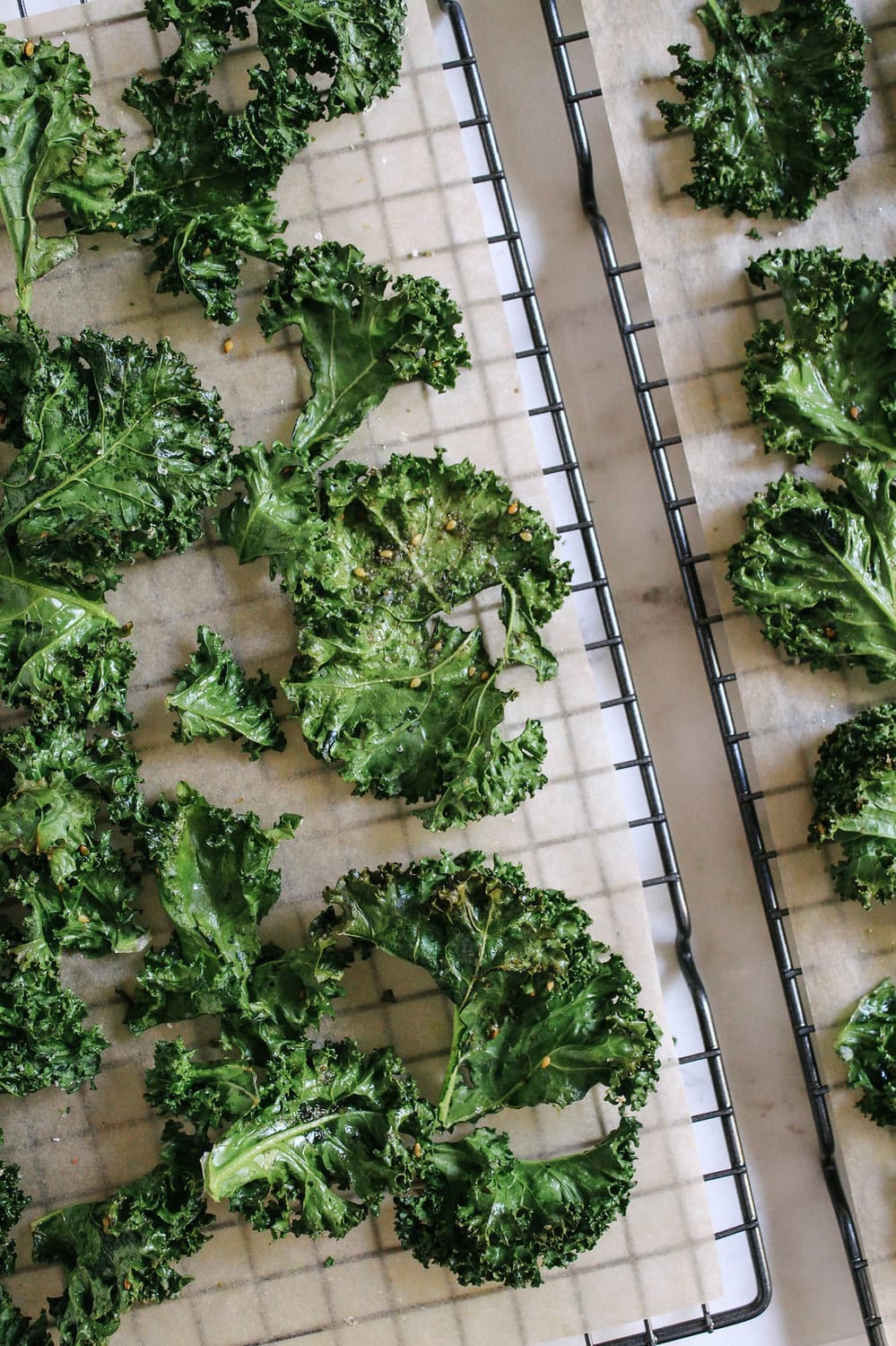 crispy baked kale chips cooling on a wire rack