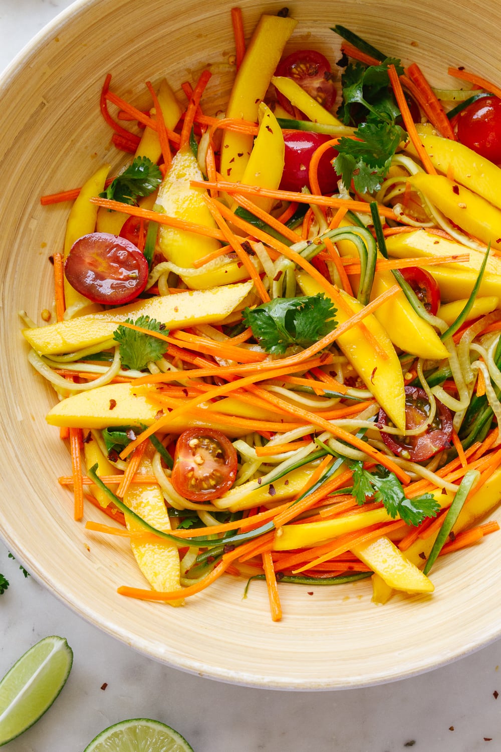 top down view of spicy mango thai salad mixed with dressing