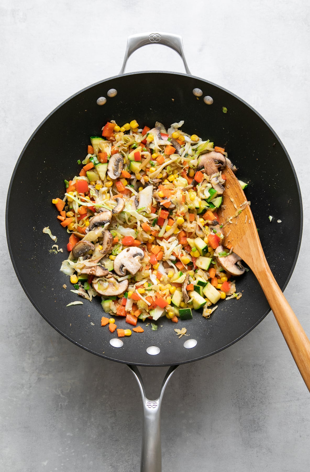 top down view of stir fried vegetables for quinoa fried rice recipe in a wok.
