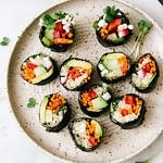 top down view of cut up vegan sushi roll on a small handmade plate