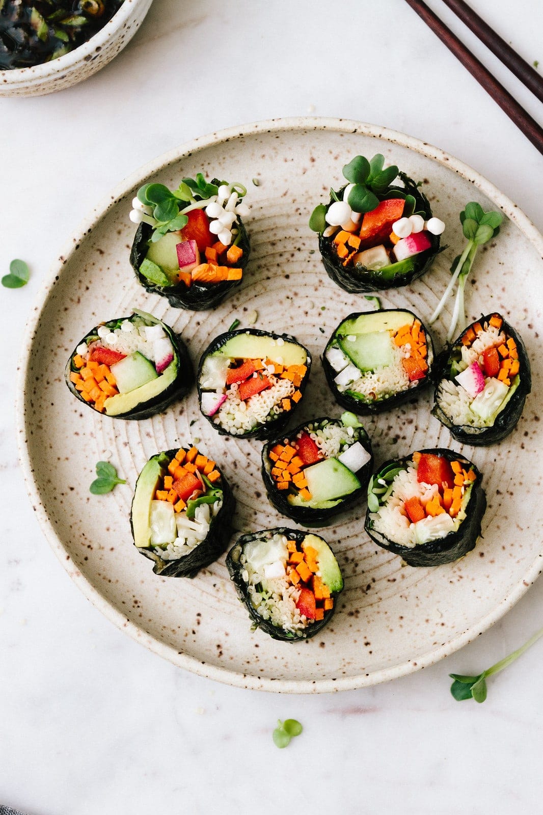 top down view of cut up vegan sushi roll on a small handmade plate