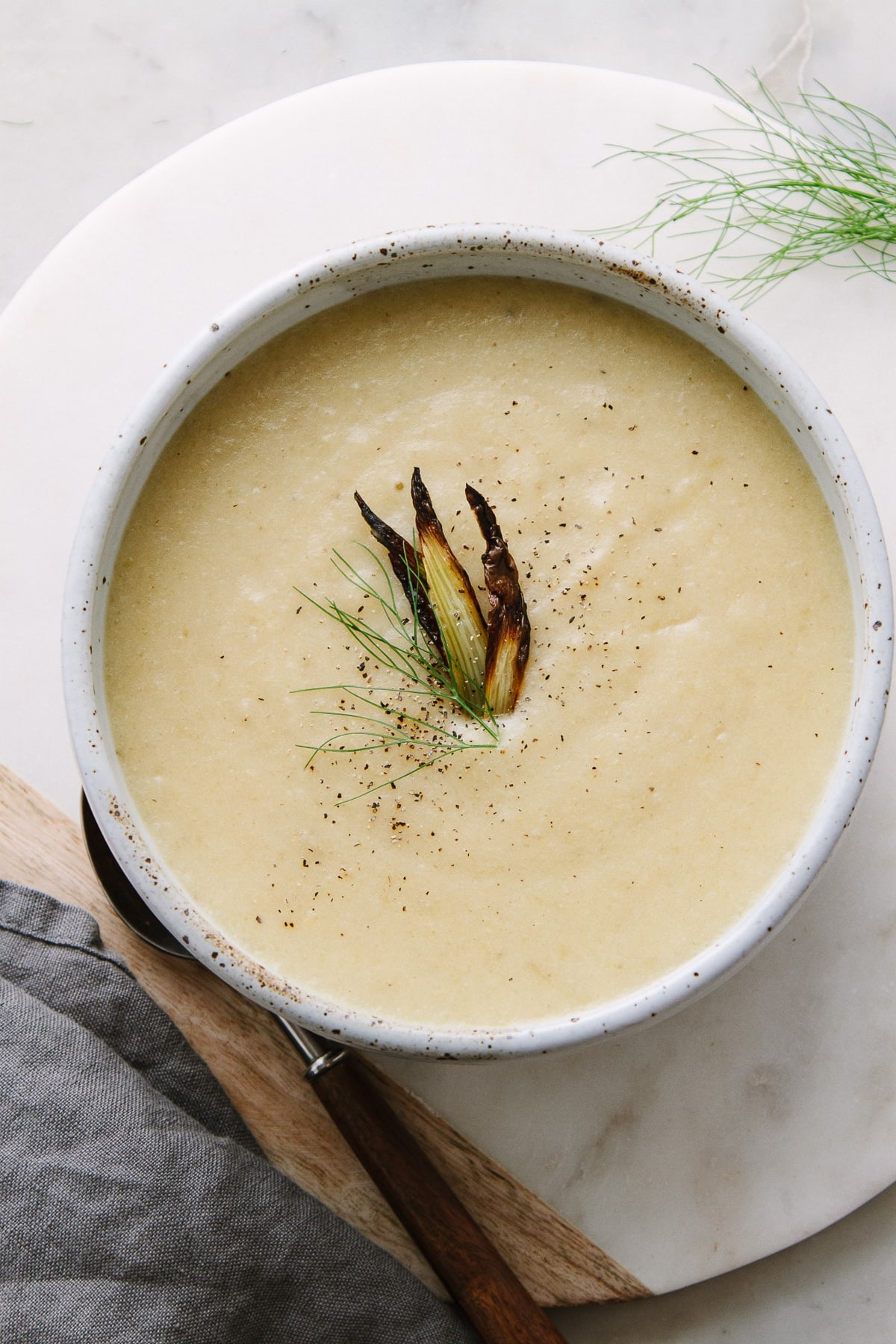 top down view of a bowl full of roasted fennel and potato soup.