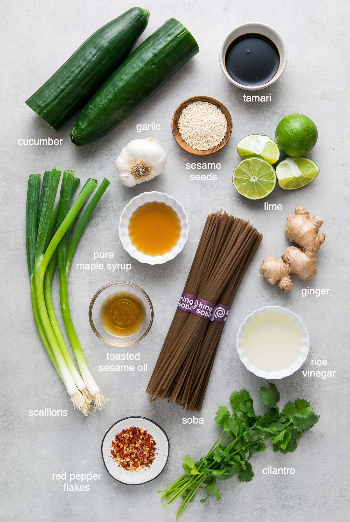 top down view of ingredients used to make sesame-ginger scallion soba noodle salad with cucumbers.