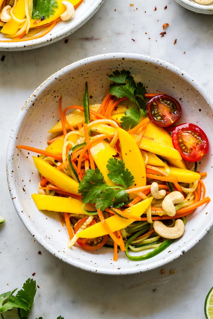 top down, up close view of bowl with a serving of spicy thai mango salad