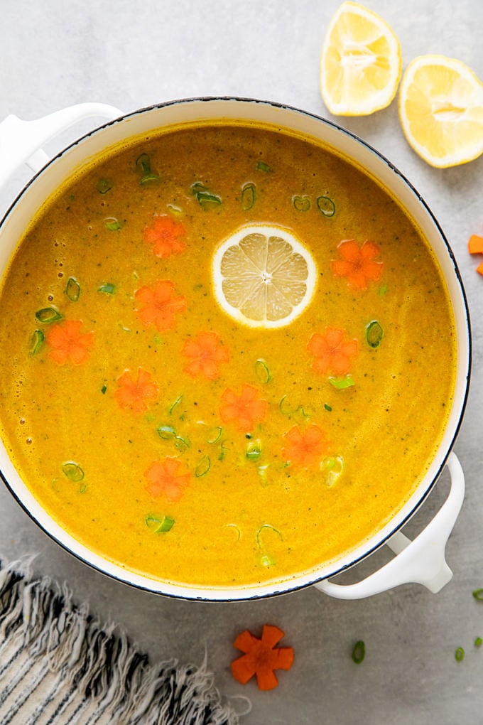 top down view of freshly made zucchini carrot soup in a white pot.