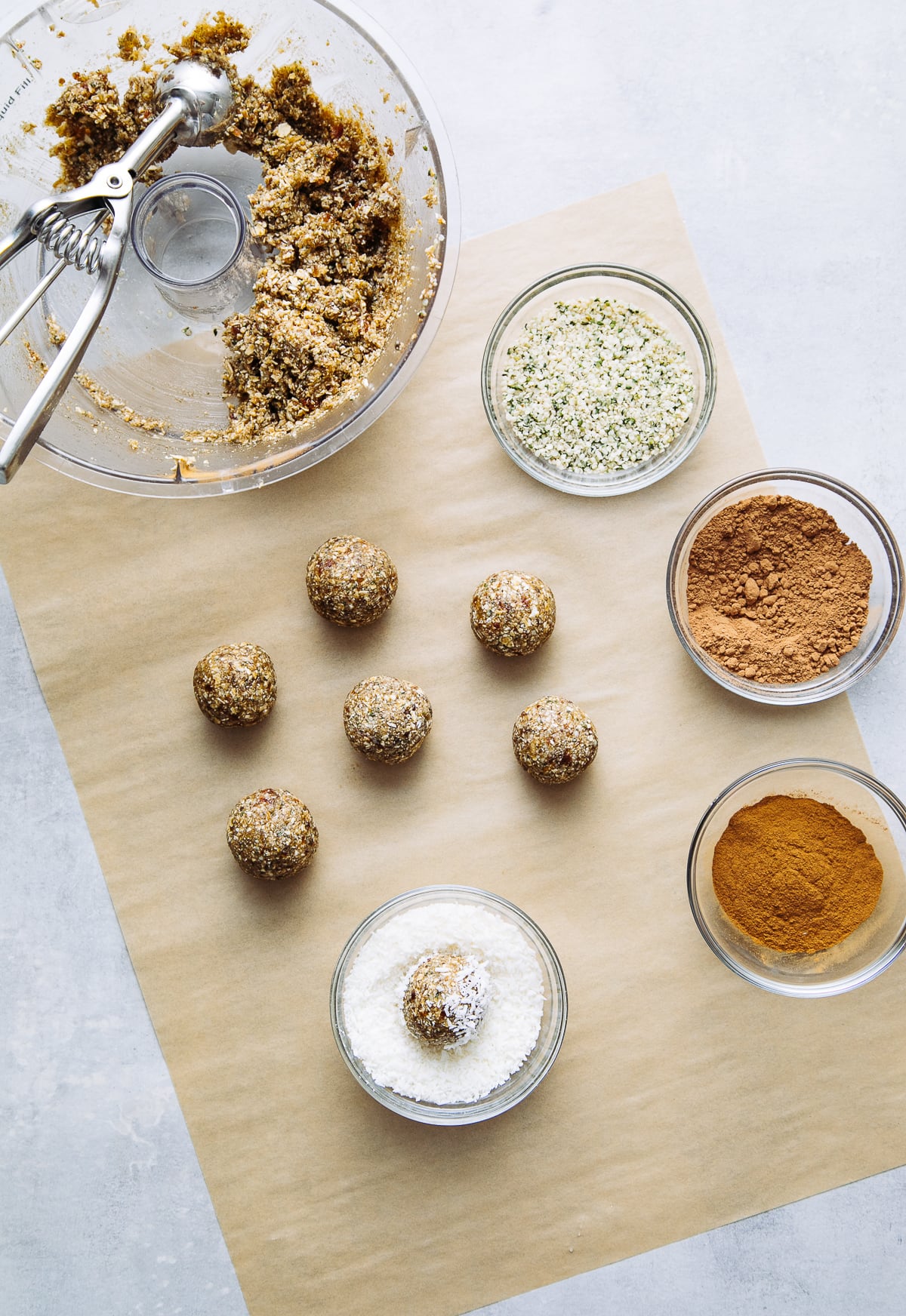 top down view showing the process of scooping and rolling energy bites dough.