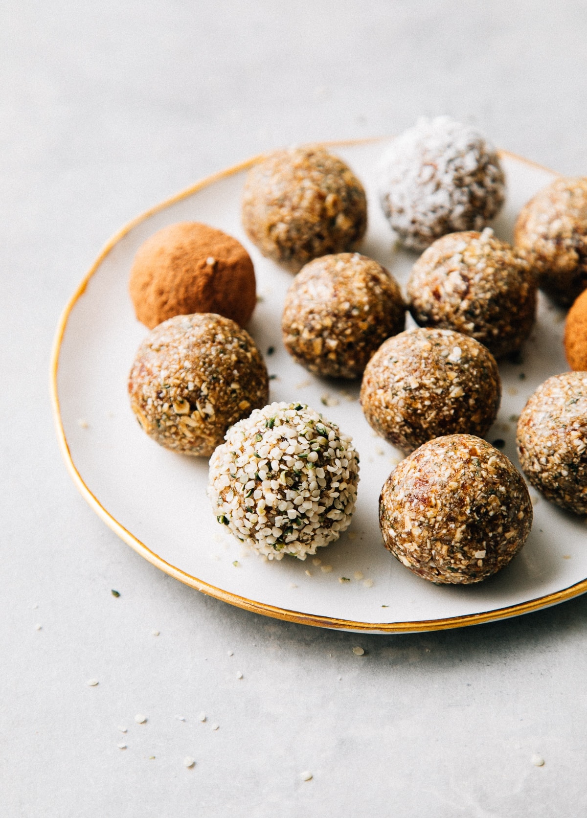 side angle view of healthy no bake hemp heart and oat energy bites on a small plate.