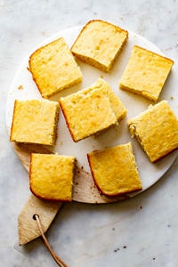 top down view of a group of cornbread slices on a marble serving tray.