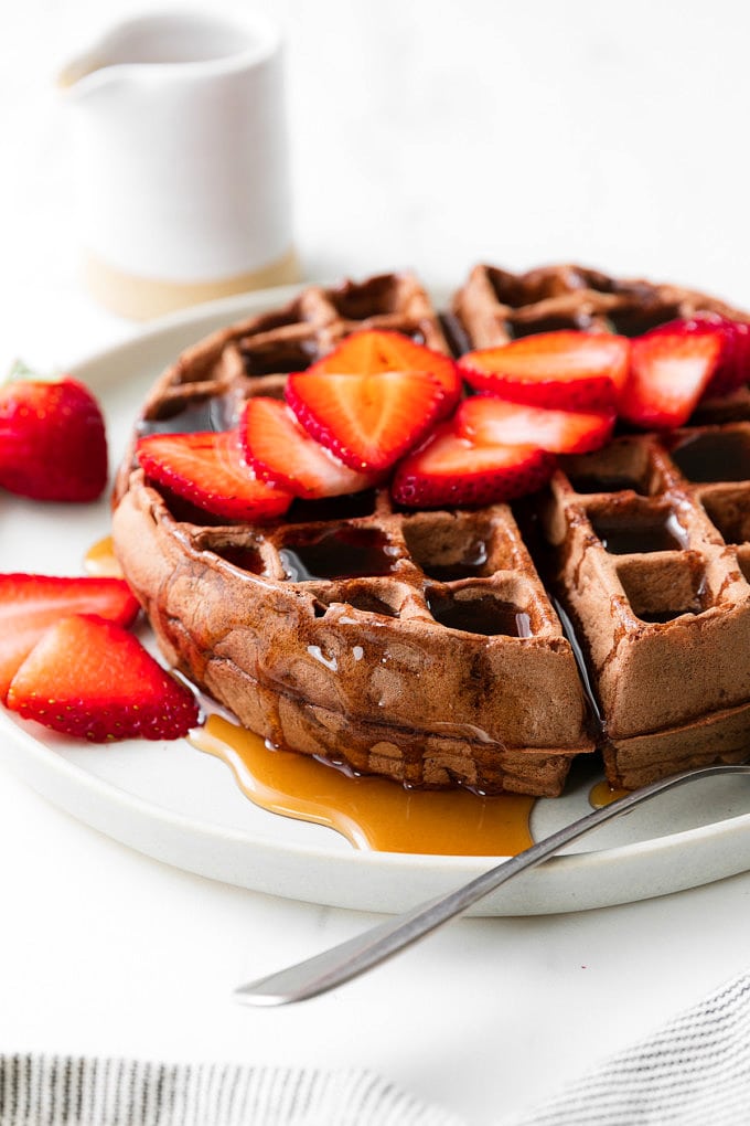 head on view of vegan chocolate belgian waffle on a plate.