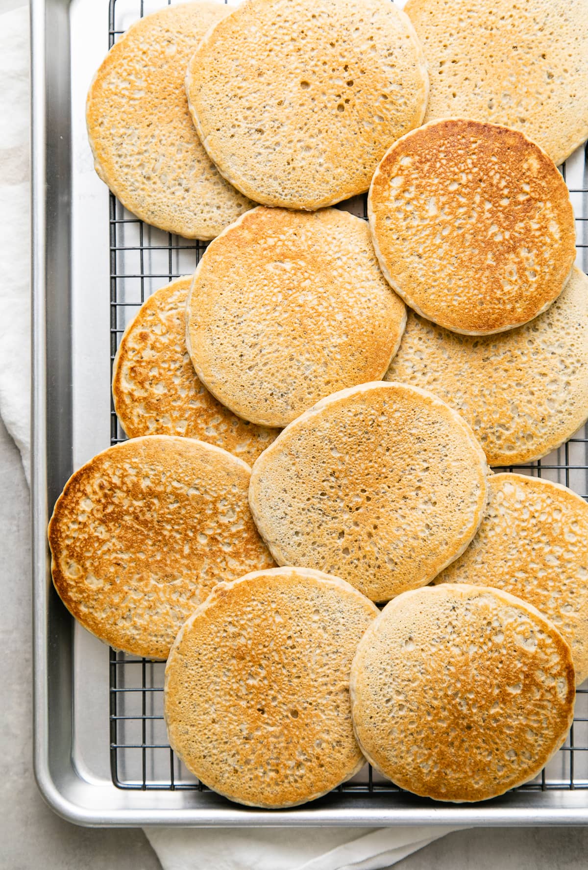 top down view of lemon chia seed pancakes cooling on a wire rack.