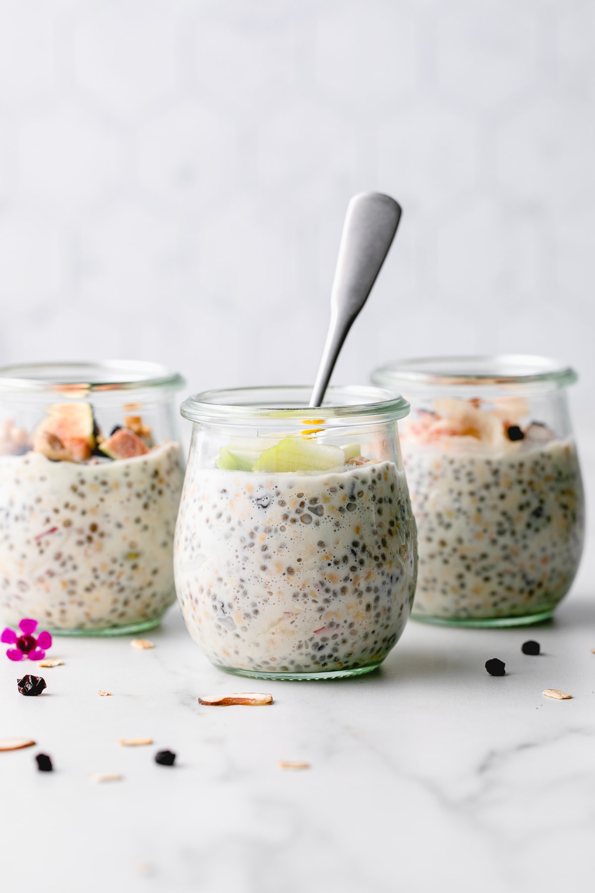 head on view of a group of glass jar filled with bircher muesli.