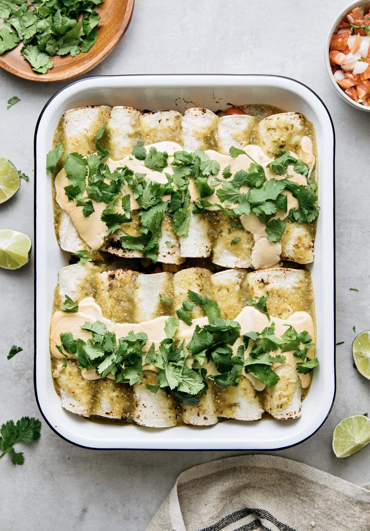 top down view of vegan enchilada verde with smoky cashew crema poured overtop.