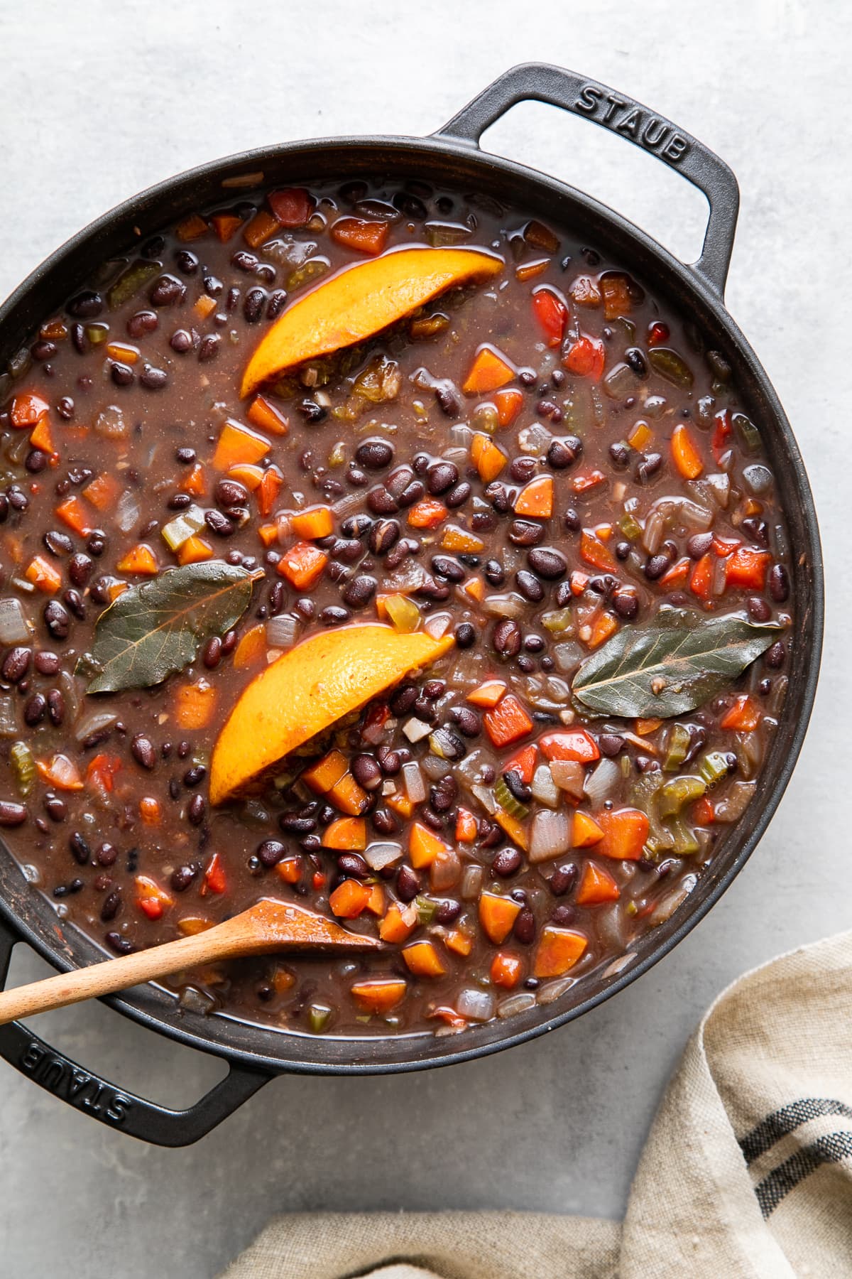 top down view of freshly made pot of cuban black bean soup in a black pot before pureeing.