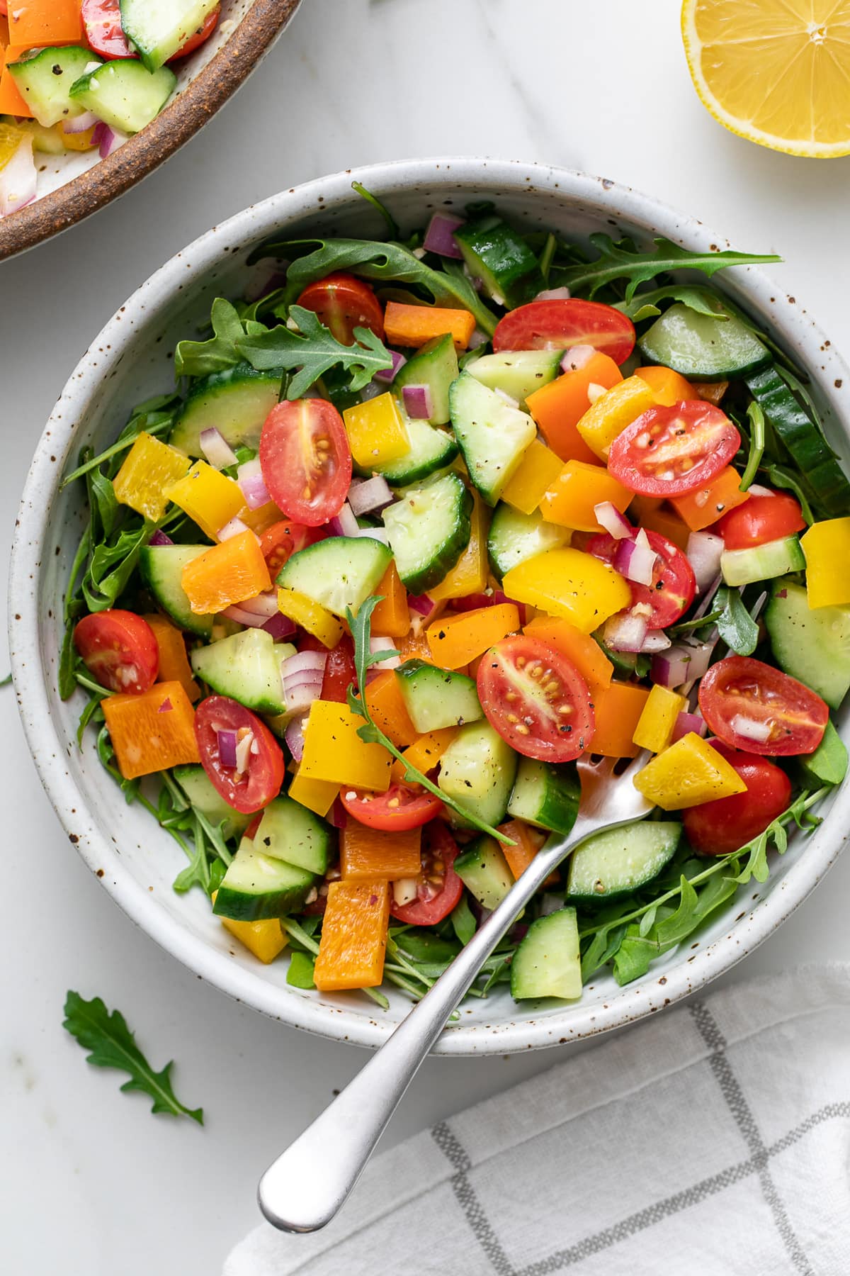 top down view of plated vegetable salad with arugula.