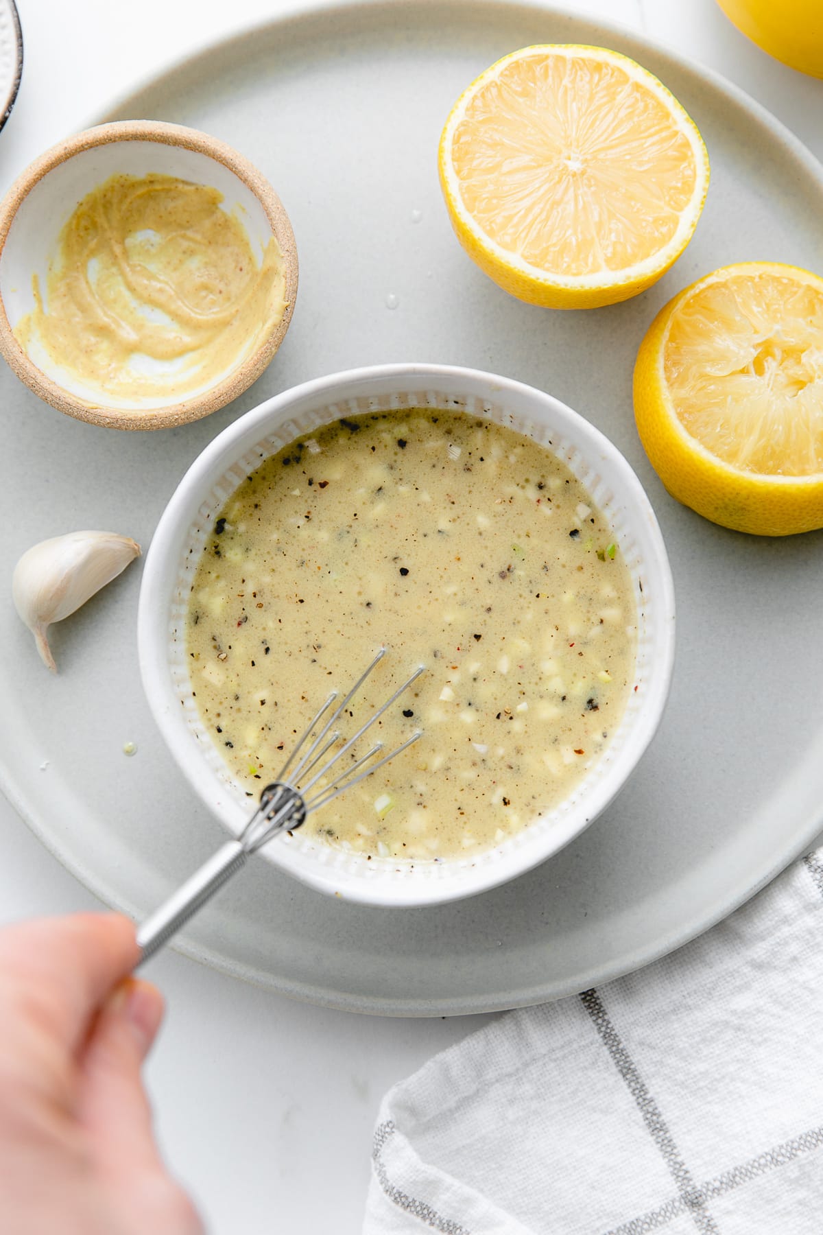 top down view of zesty lemon garlic dressing being made in a small bowl.