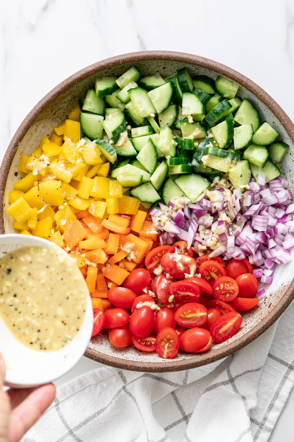 top down view of ingredients added to bowl and dressing poured over top.