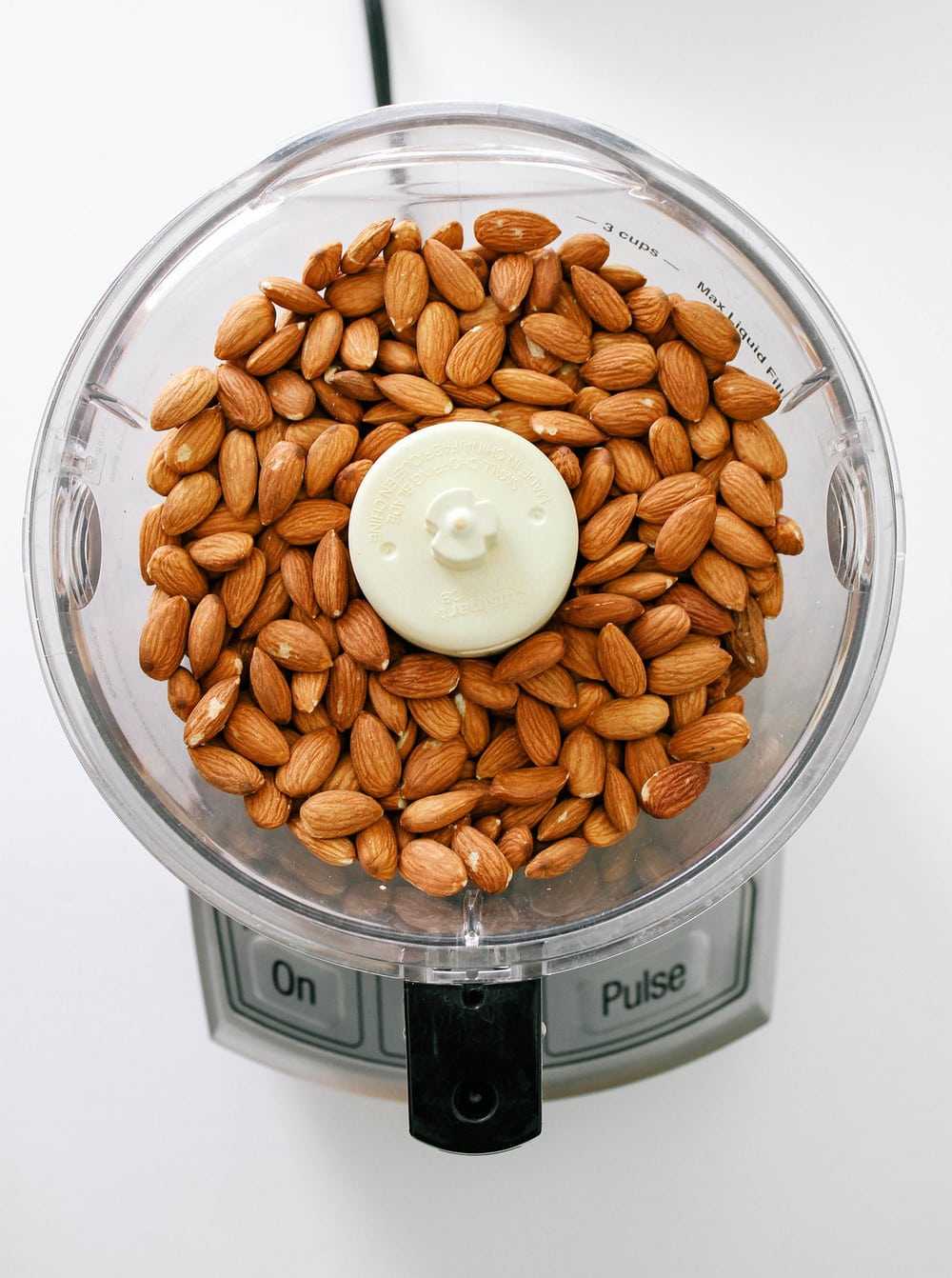 almond added to the bottom of a food processor before starting to blend