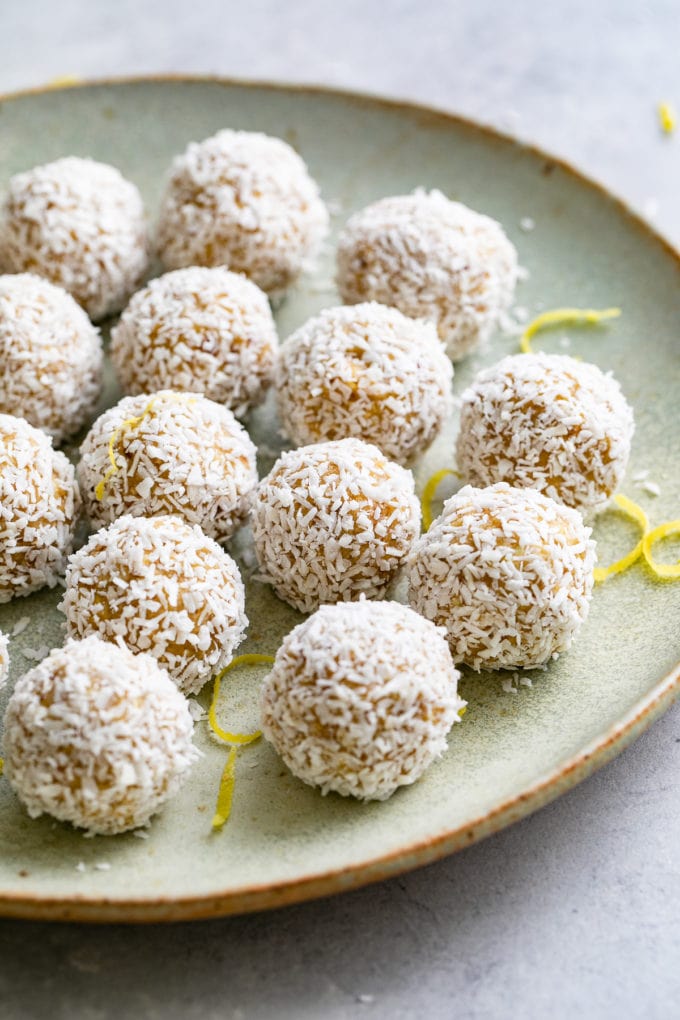 side angle view of coconut lemon energy bites on a plate.