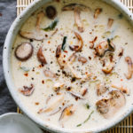 raw creamy miso soup with mushrooms in a rustic handmade bowl with a white spoon