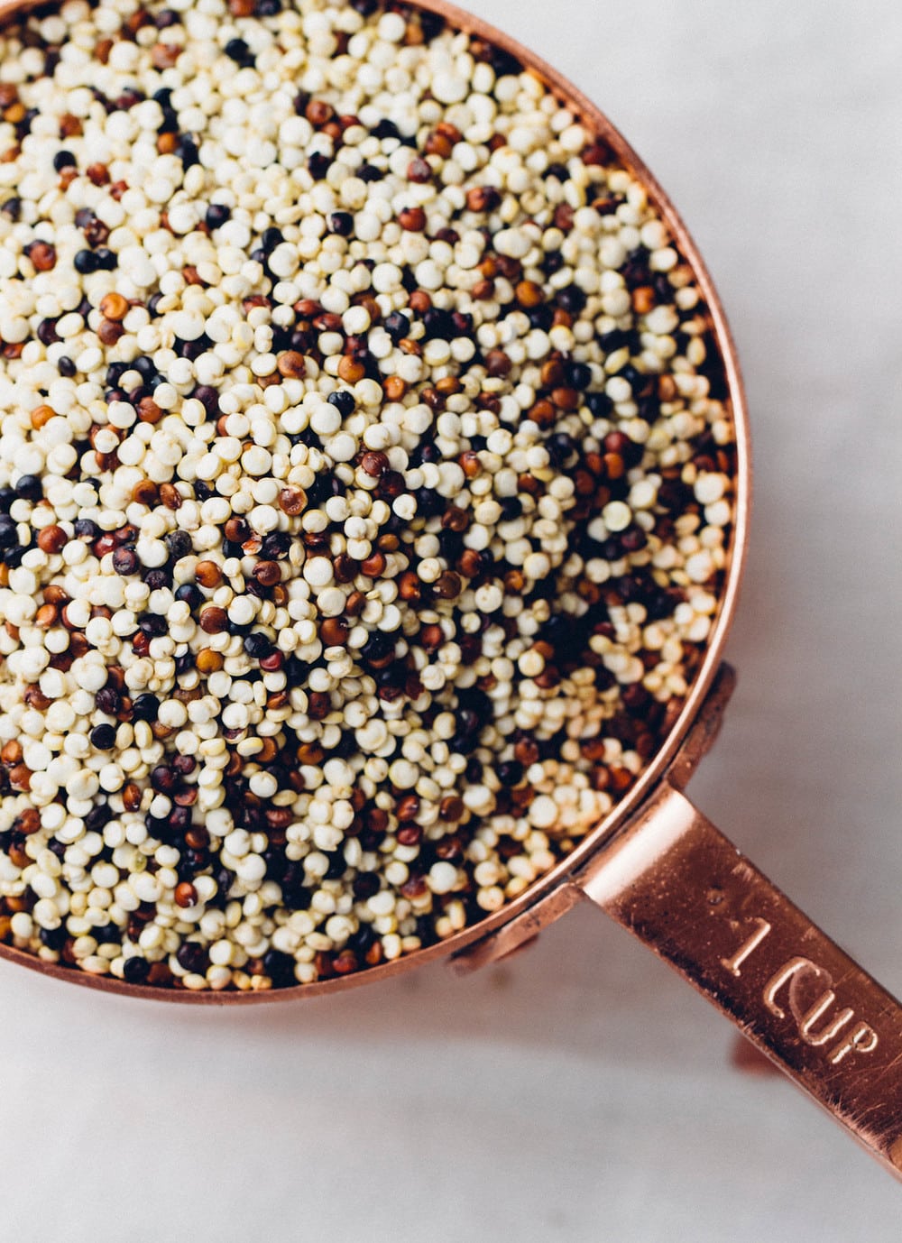 top down view of dried quinoa in a measuring cup