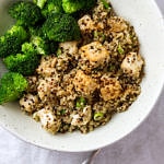 top down view of sesame quinoa and tofu with steamed broccoli in a bowl