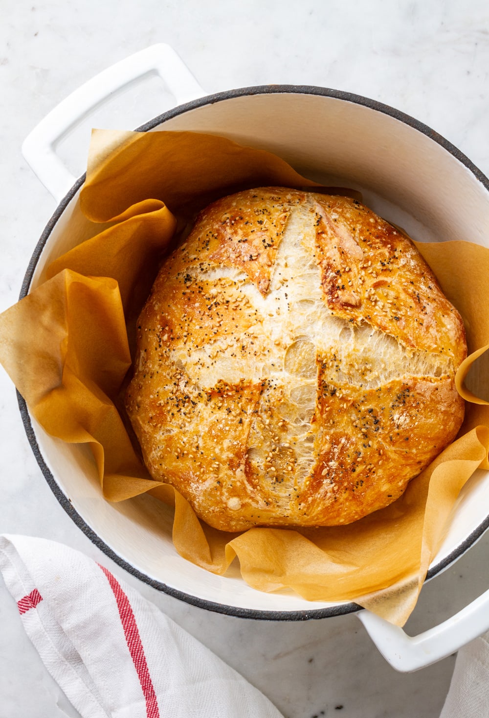 fresh baked no knead bread in a dutch oven just pulled from the oven