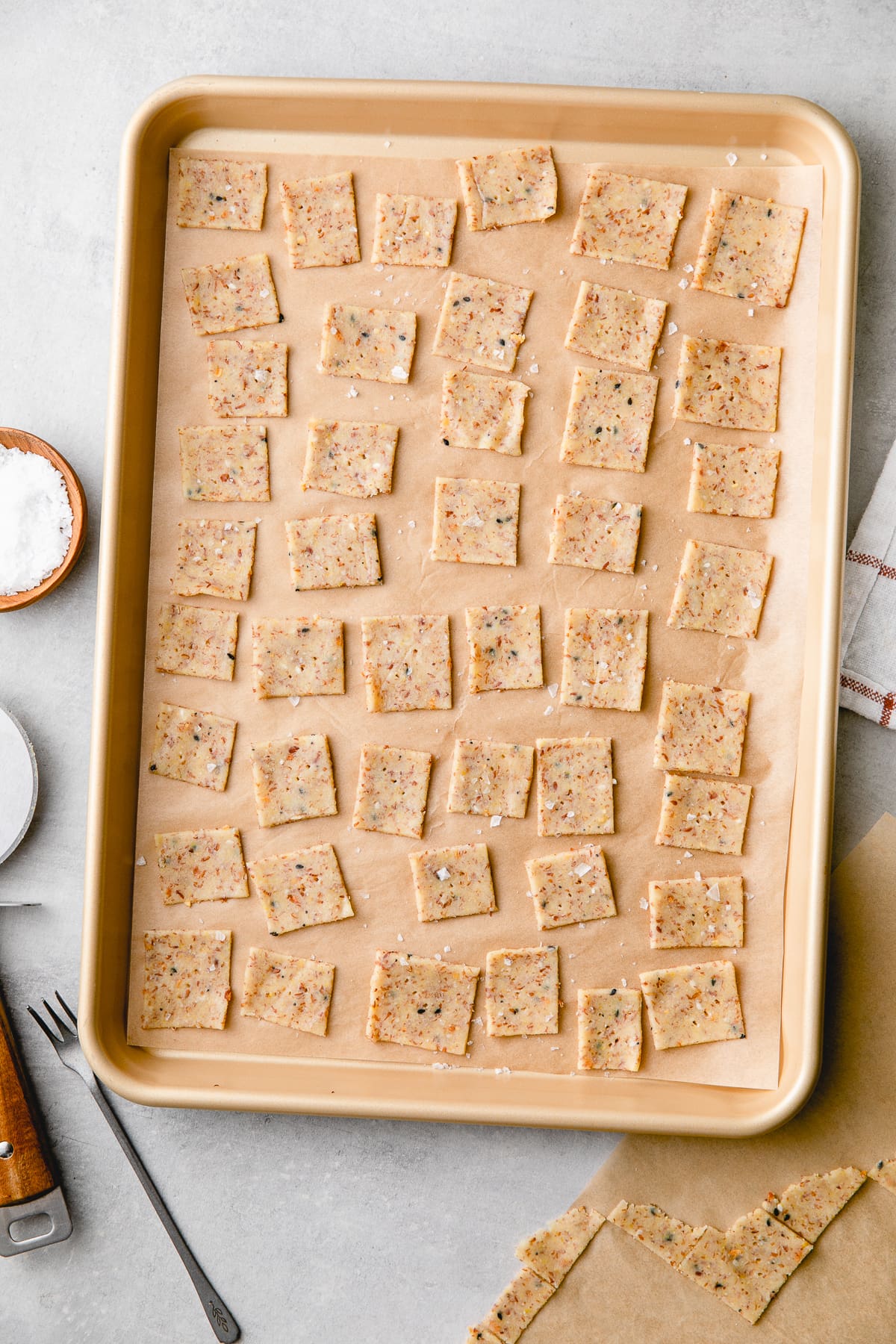 top down view of grain free almond flour crackers ready for the oven on a baking sheet.