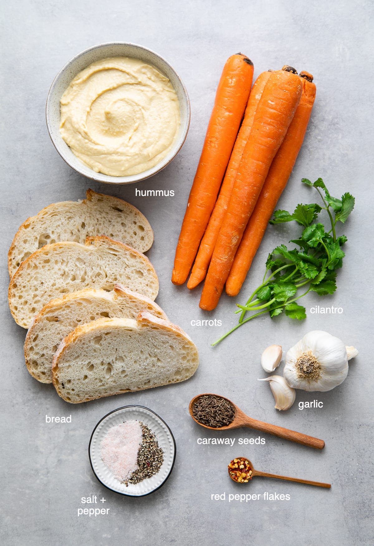top down view of ingredients used to make healthy spicy carrot and hummus sandwich.