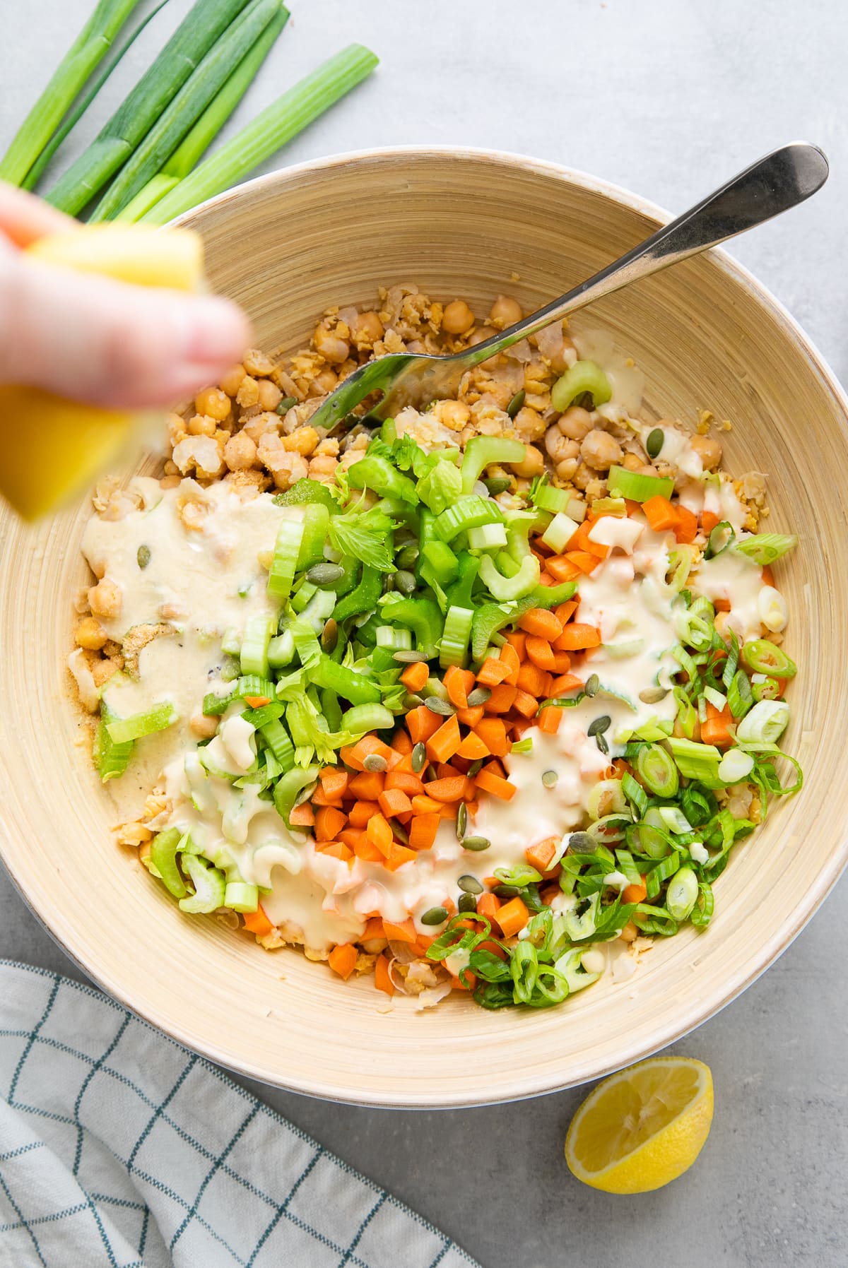 top down view showing the process of making mashed chickpea salad.