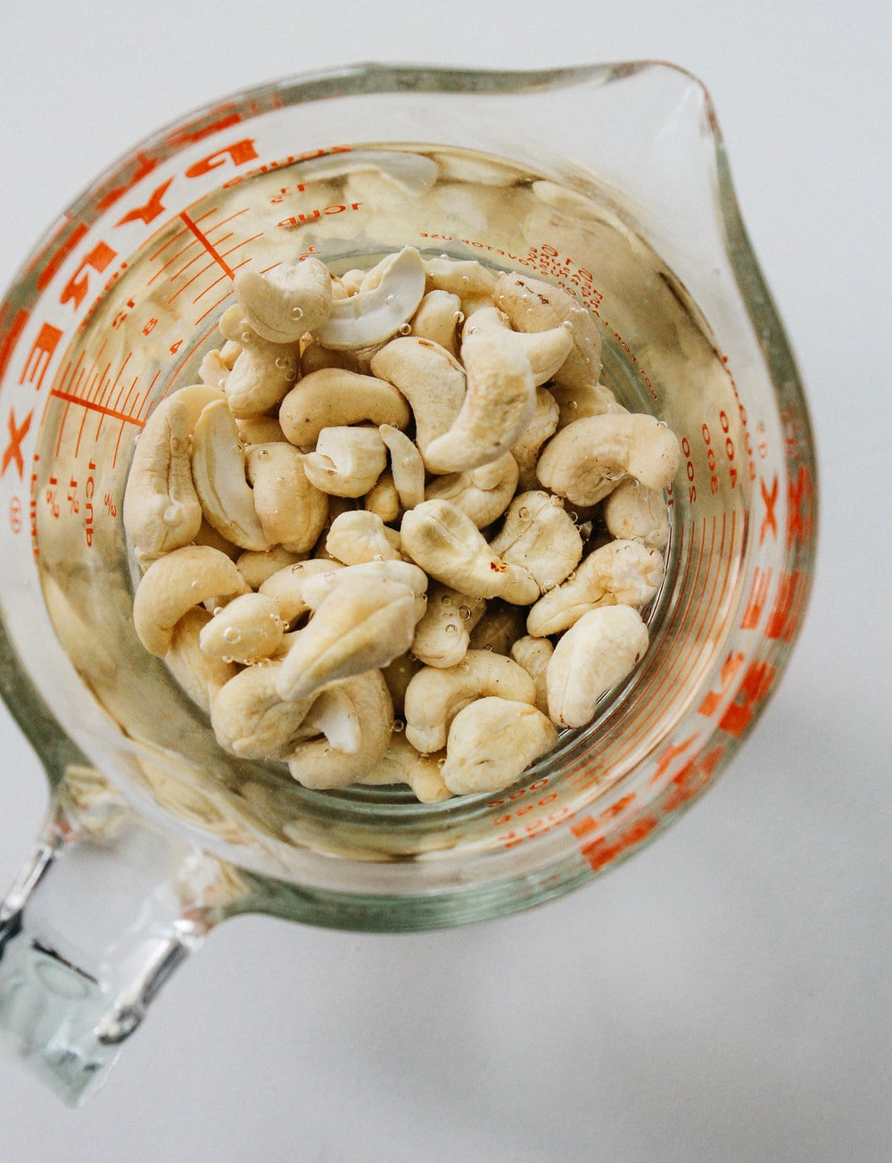 cashew soaking in water in a glass measuring cup