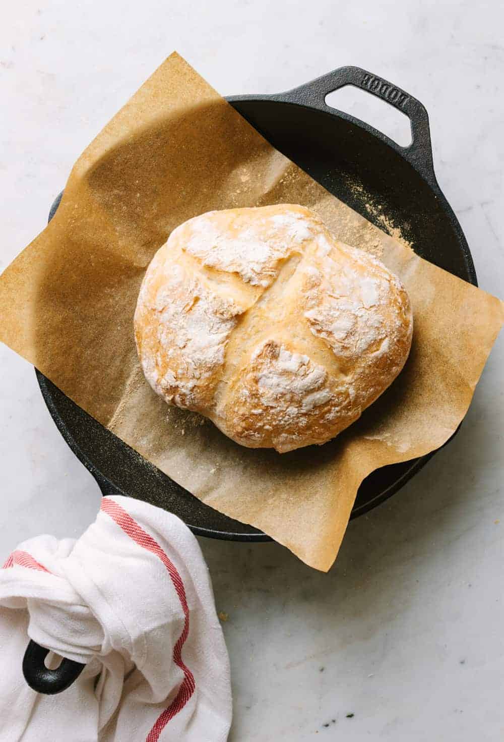no knead artisan bread fresh from the oven in a cast iron skillet