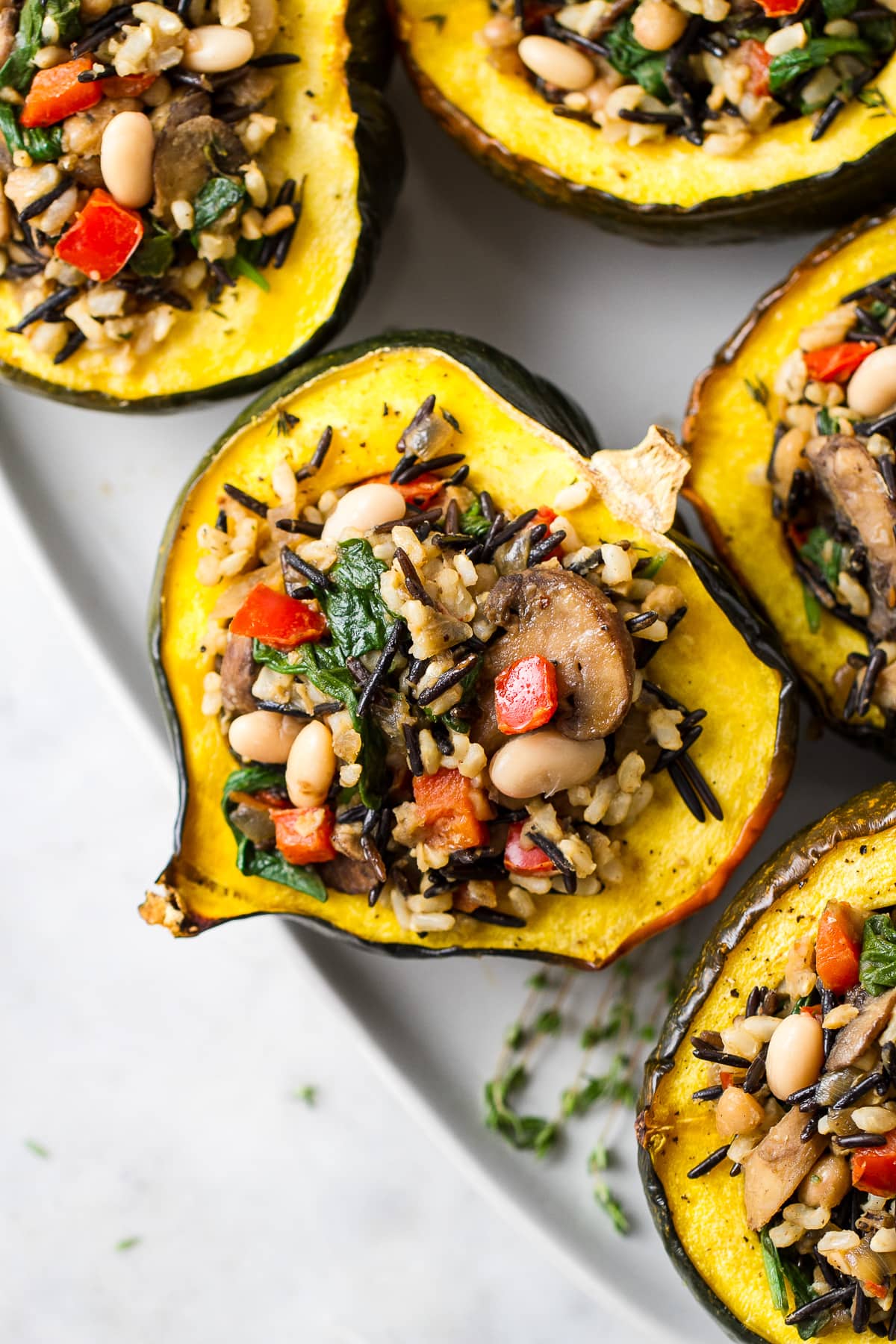 top down view of healthy roasted acorn squash with wild rice medley.