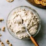 vegan cashew ricotta cheese in a bowl with wooden butter knife
