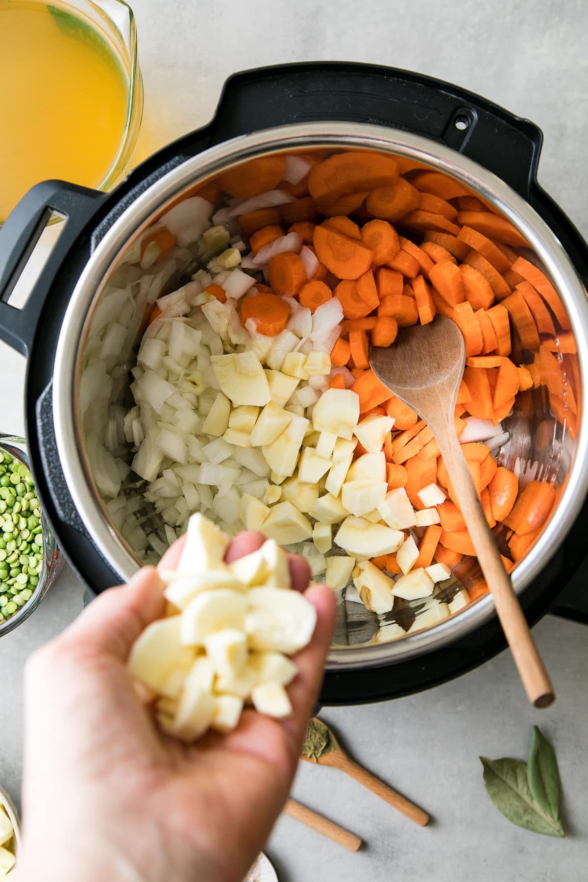 top down view of parsnips being added to Instant Pot to saute.