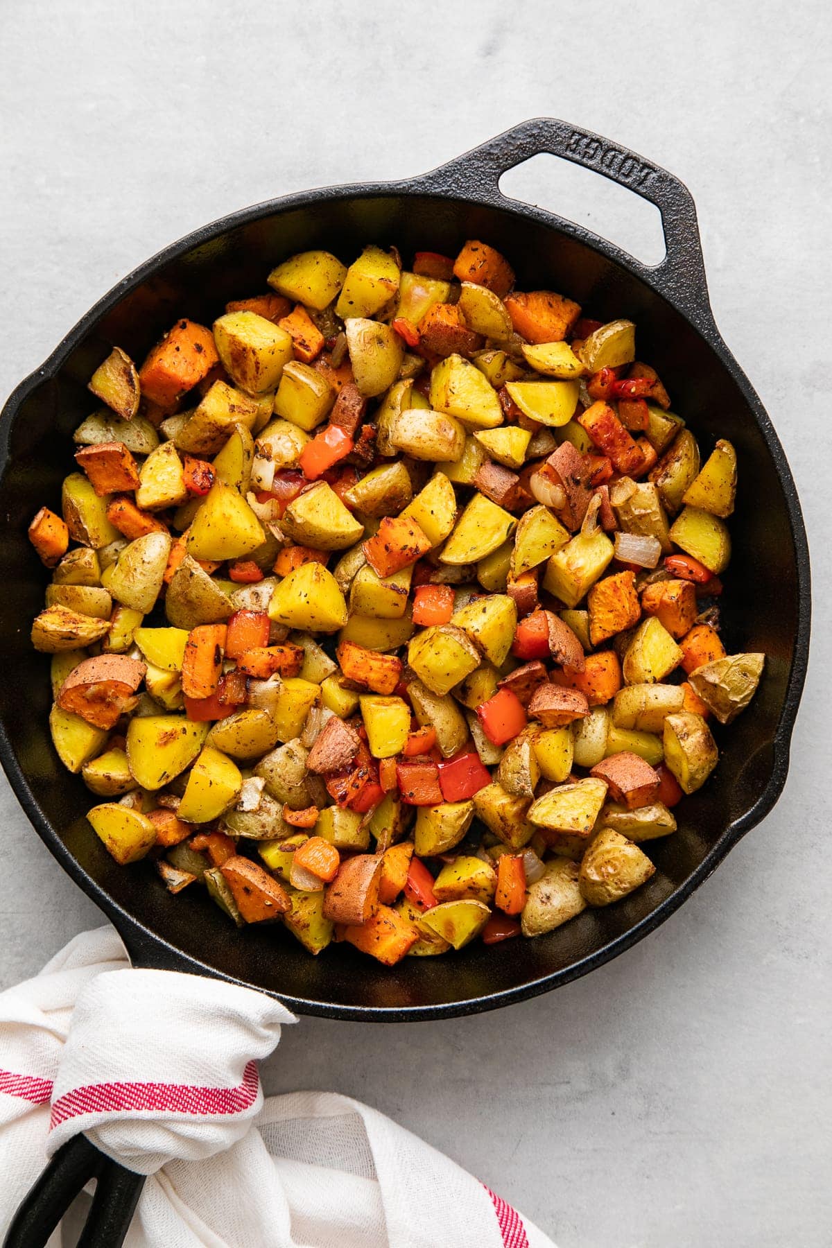 top down view of freshly made gold and sweet potatoes in a skillet.