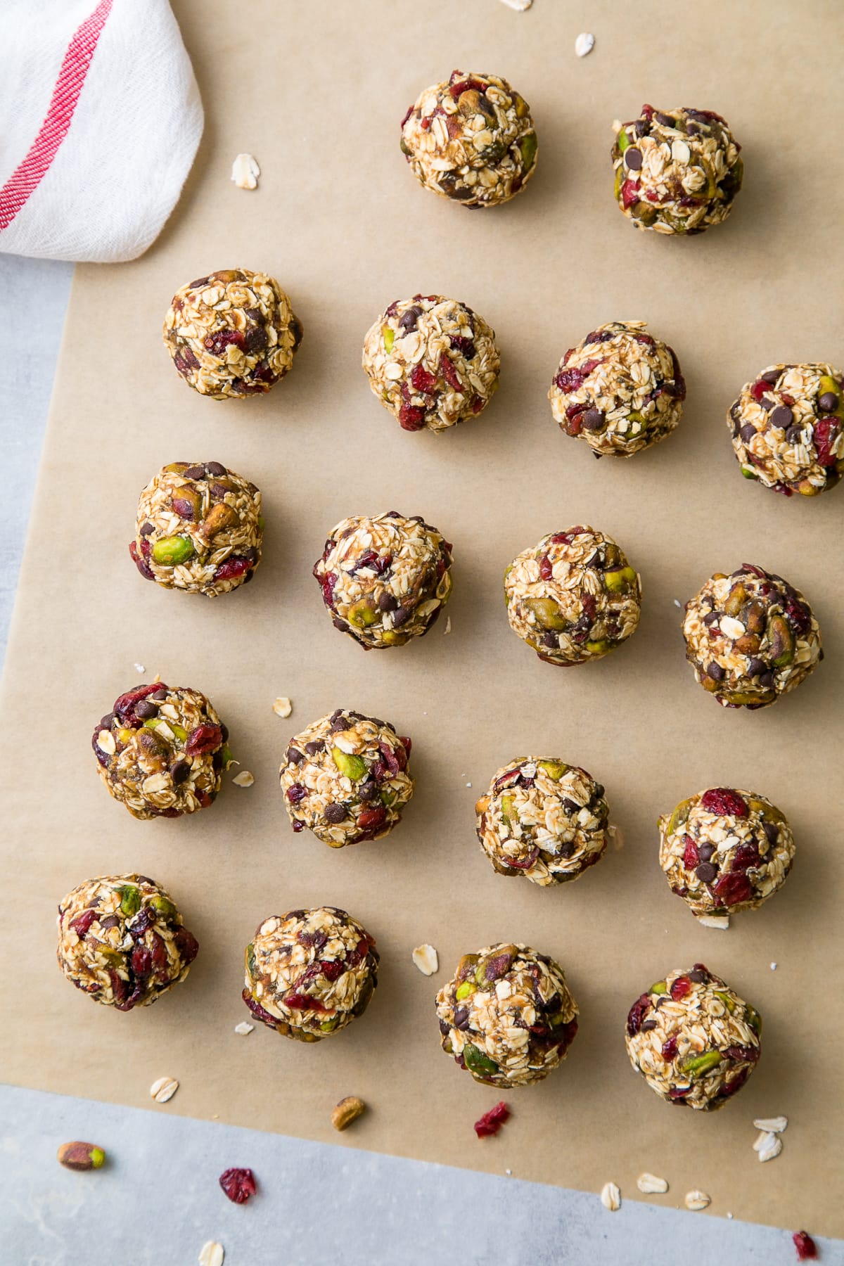 top down view of freshly rolled oatmeal energy bites with pistachios and cranberries.