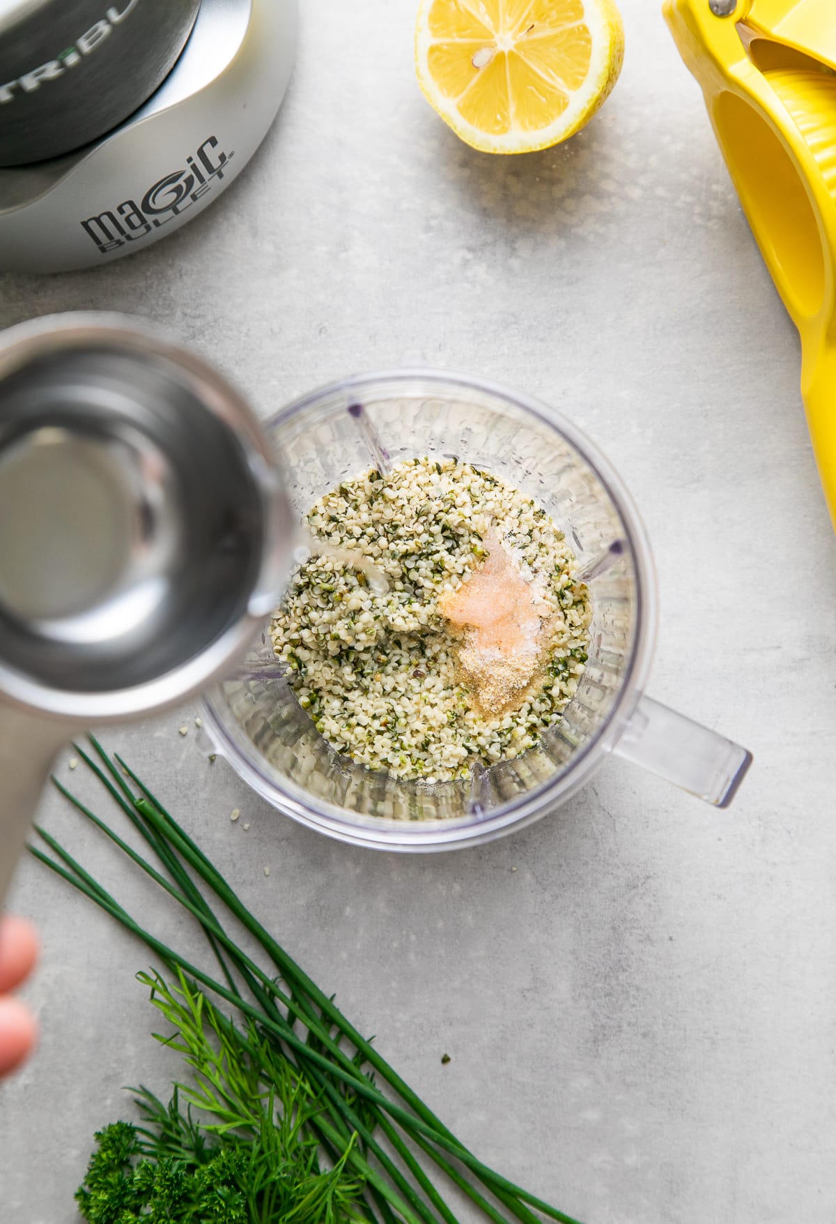 top down view showing the process of adding water to ingredients for hemp dressing.