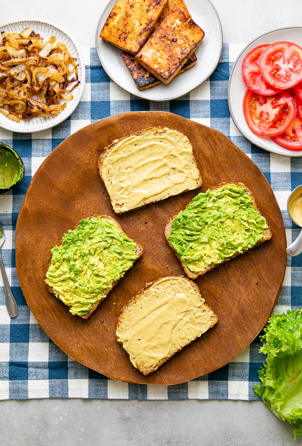 top down view showing bread slices slathered with dijon and avocado.