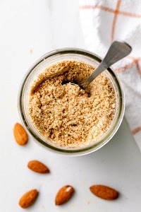 top down view of almond parmesan in a mason jar with spoon.