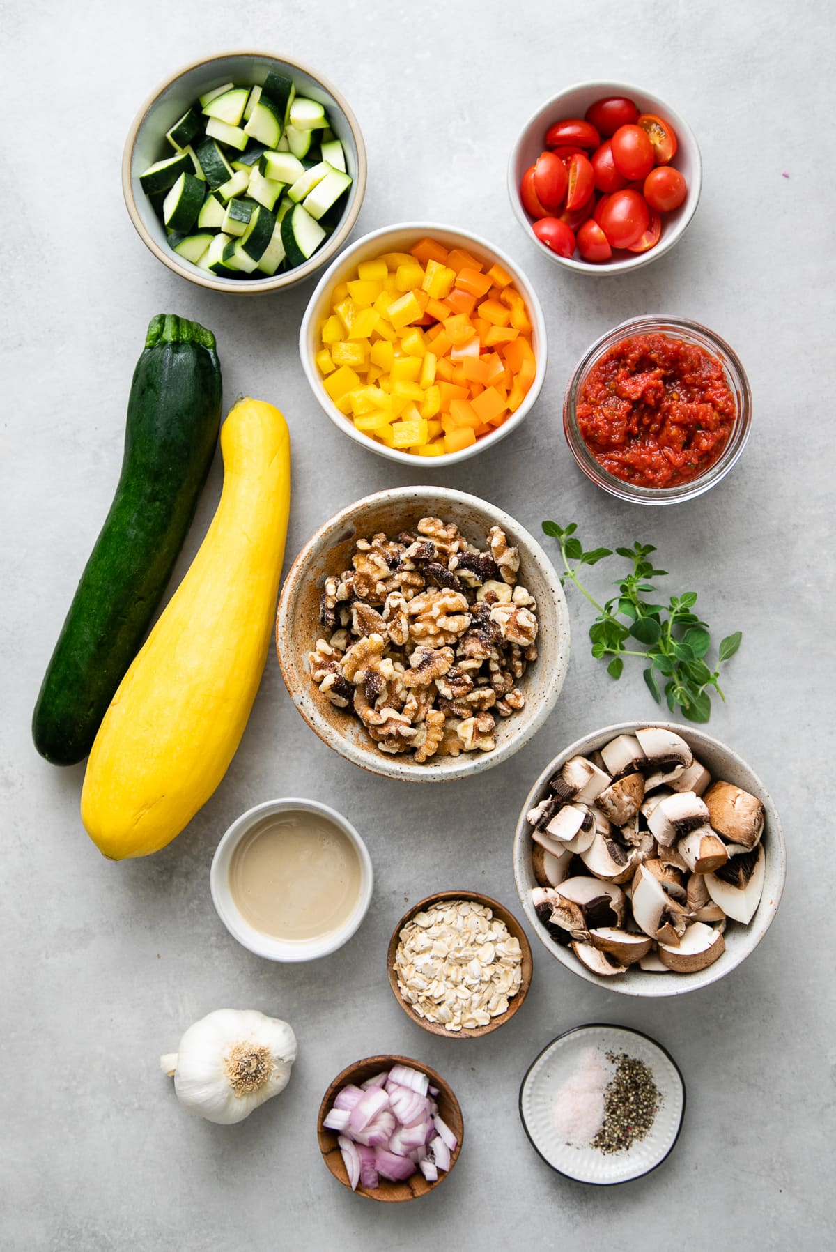 top down view of ingredients used to make raw pasta primavera and meatballs.