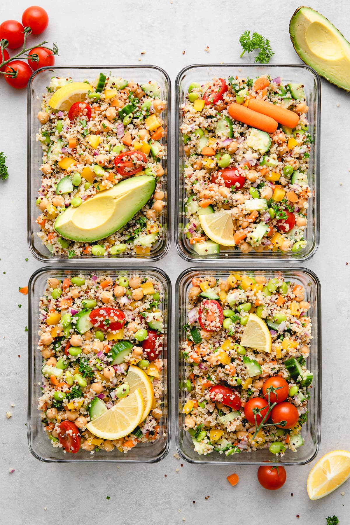 top down view of meal prepped vegan quinoa salad in glass containers.
