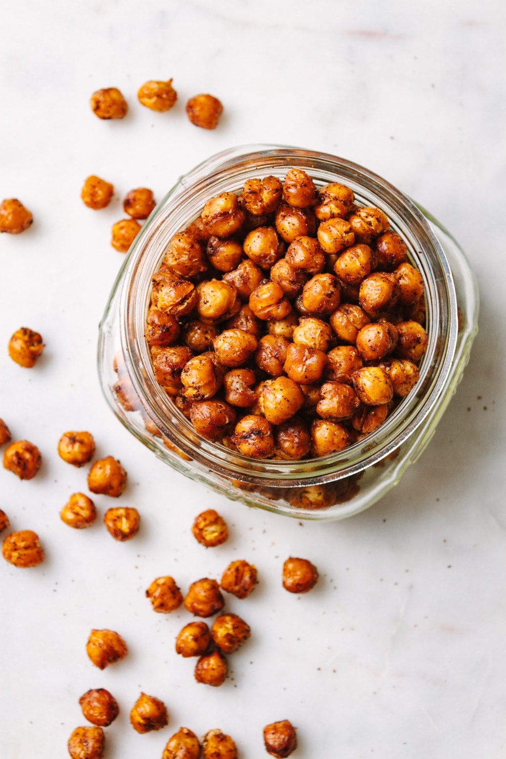 top down view of a glass jar filled with chipotle roasted chickpeas.