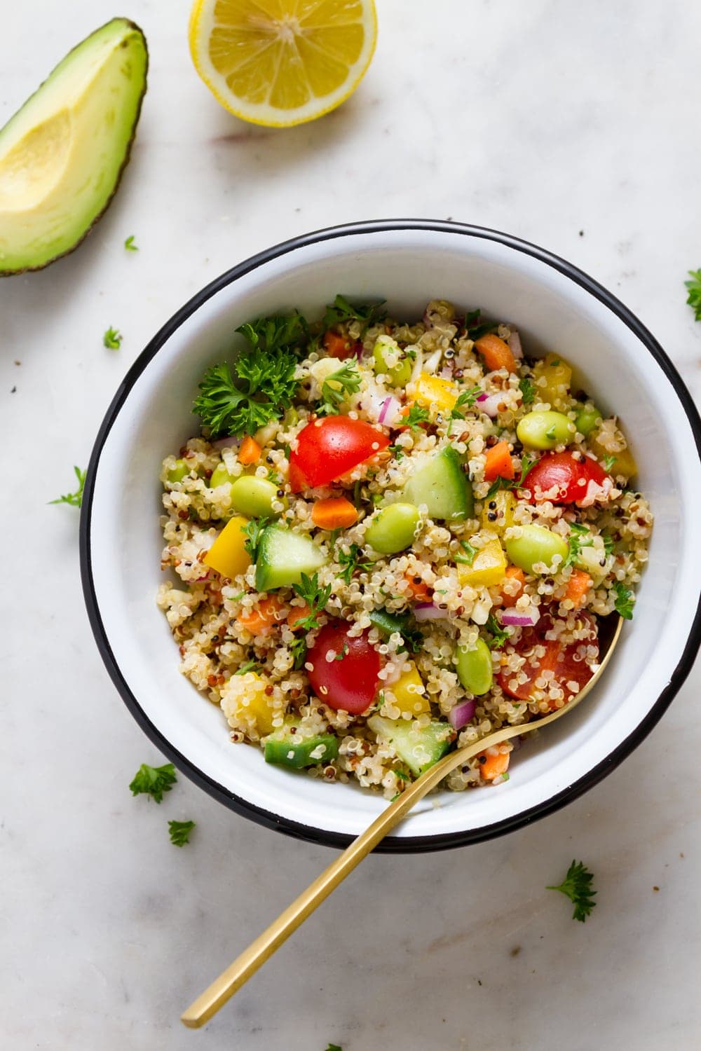 top down view of vegan quinoa salad in a bowl with spoon.