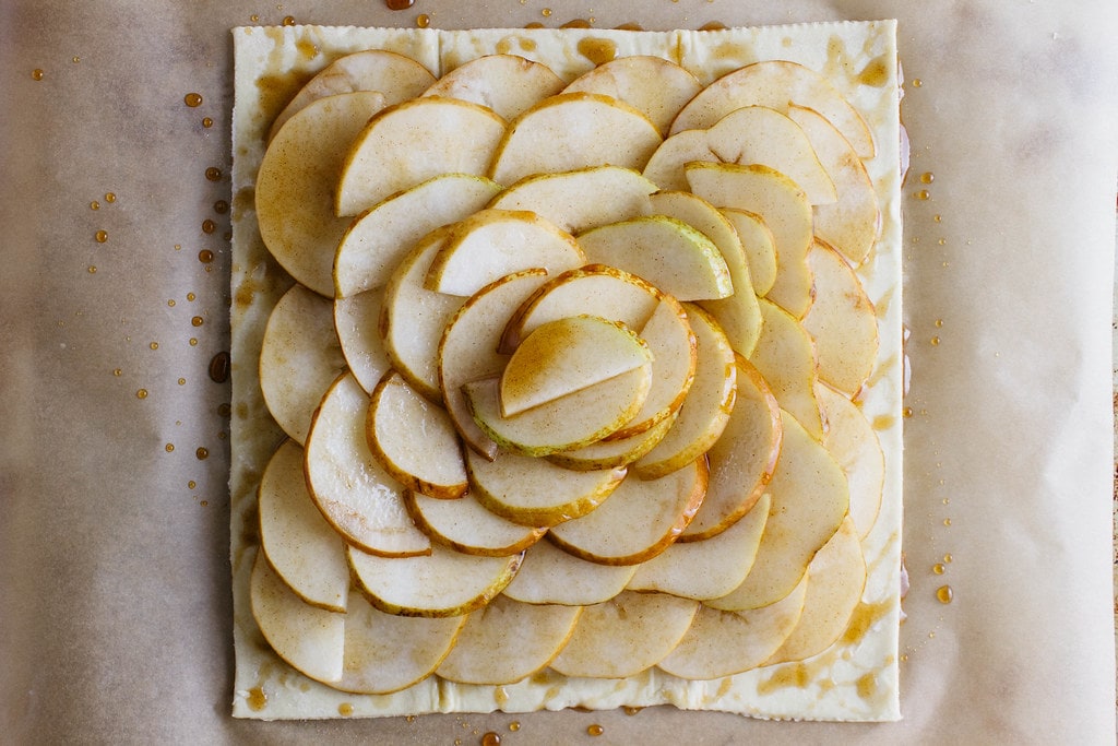 top down view of pears slices on pastry dough.