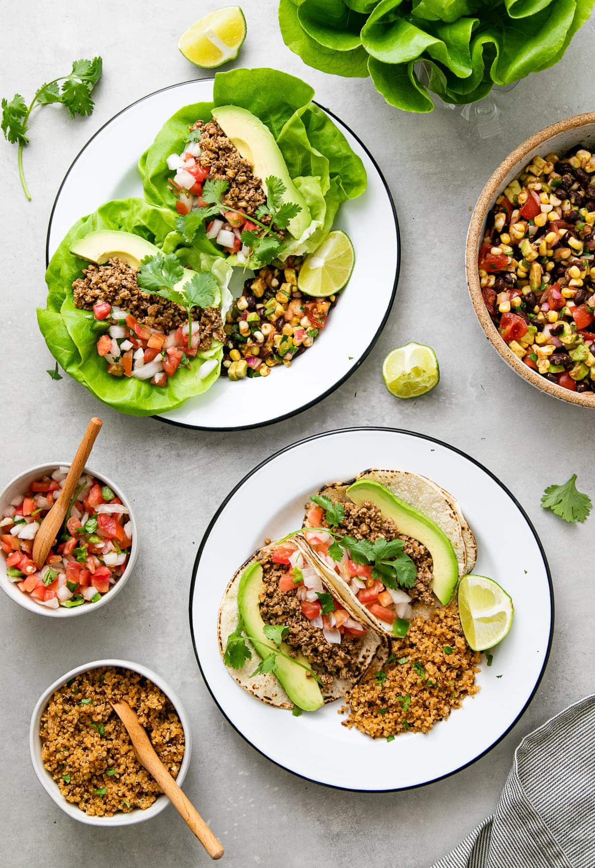 top down view of vegan street tacos on white plates with items surrounding.