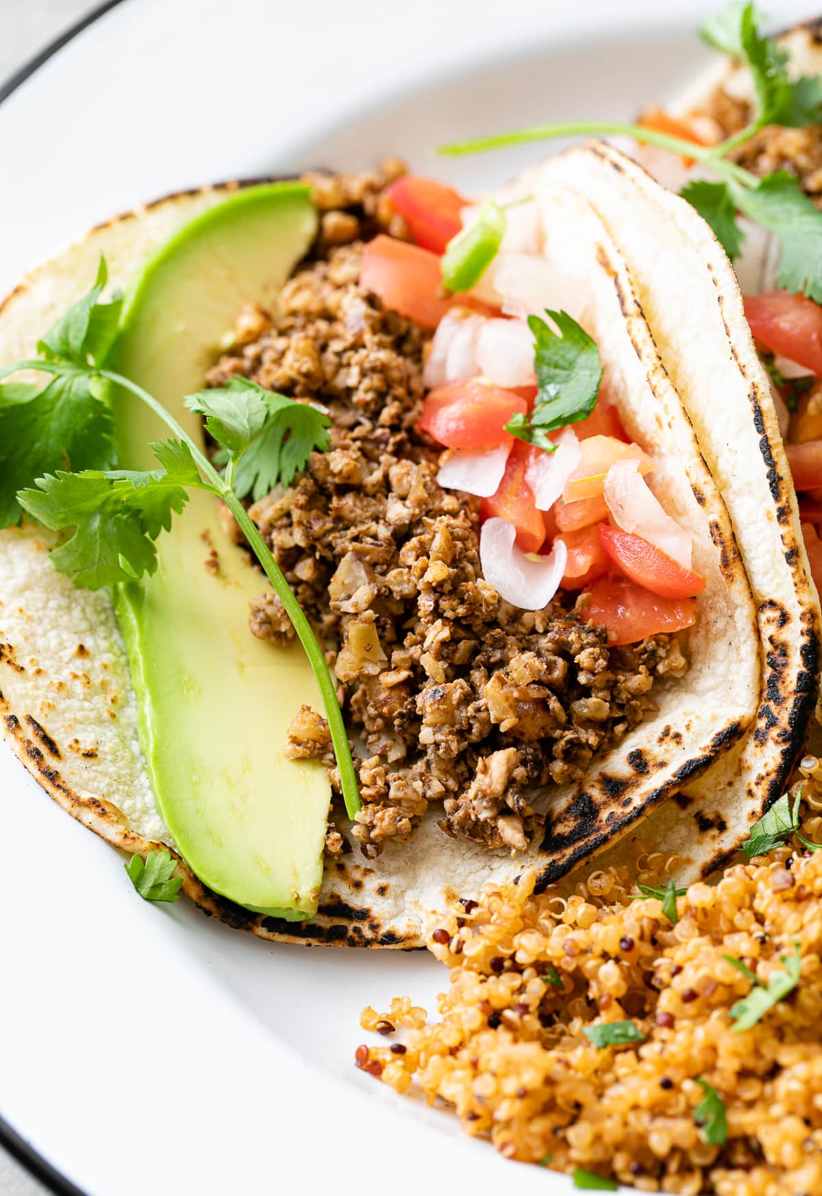 up close view of vegan street tacos with walnut meat on corn tortillas.