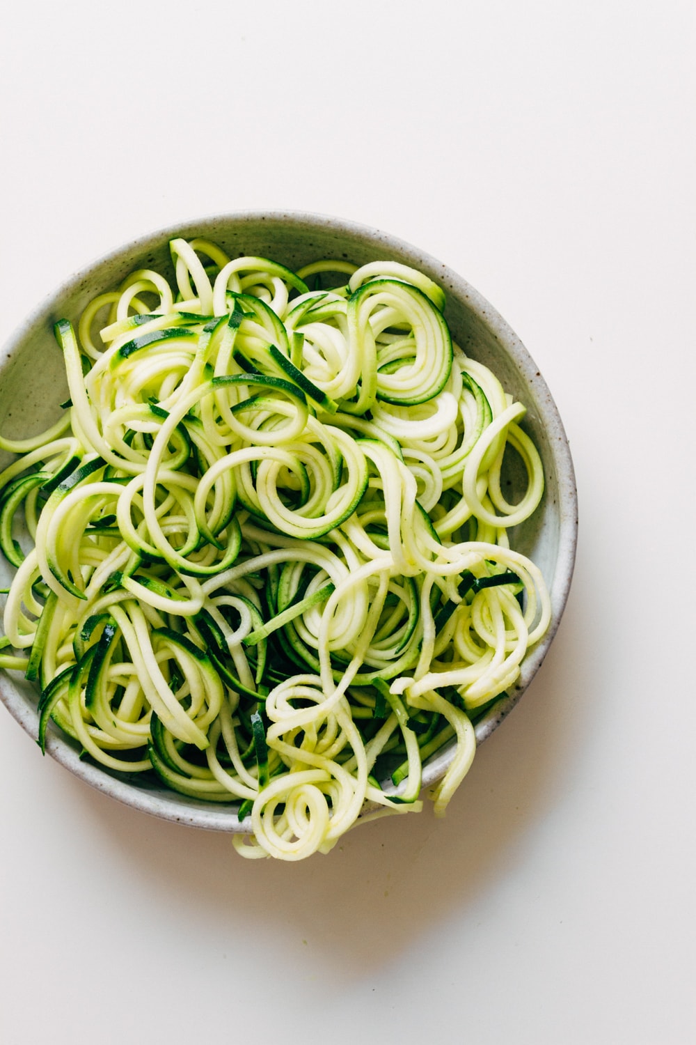 a bowl full of zucchini noodles