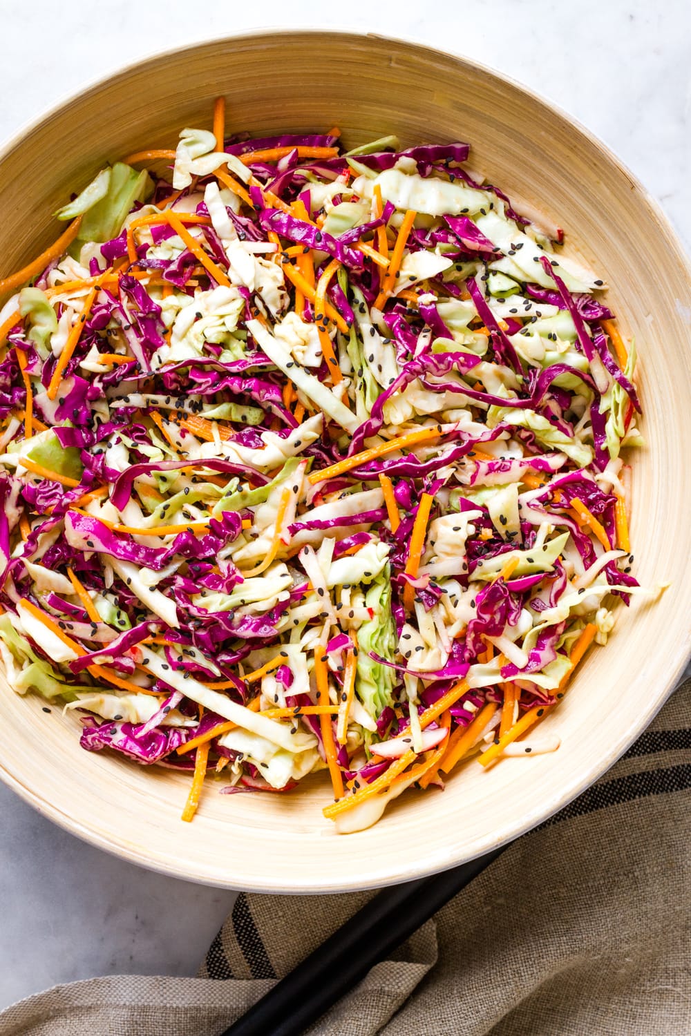 top down view of asian slaw salad in a serving bowl.