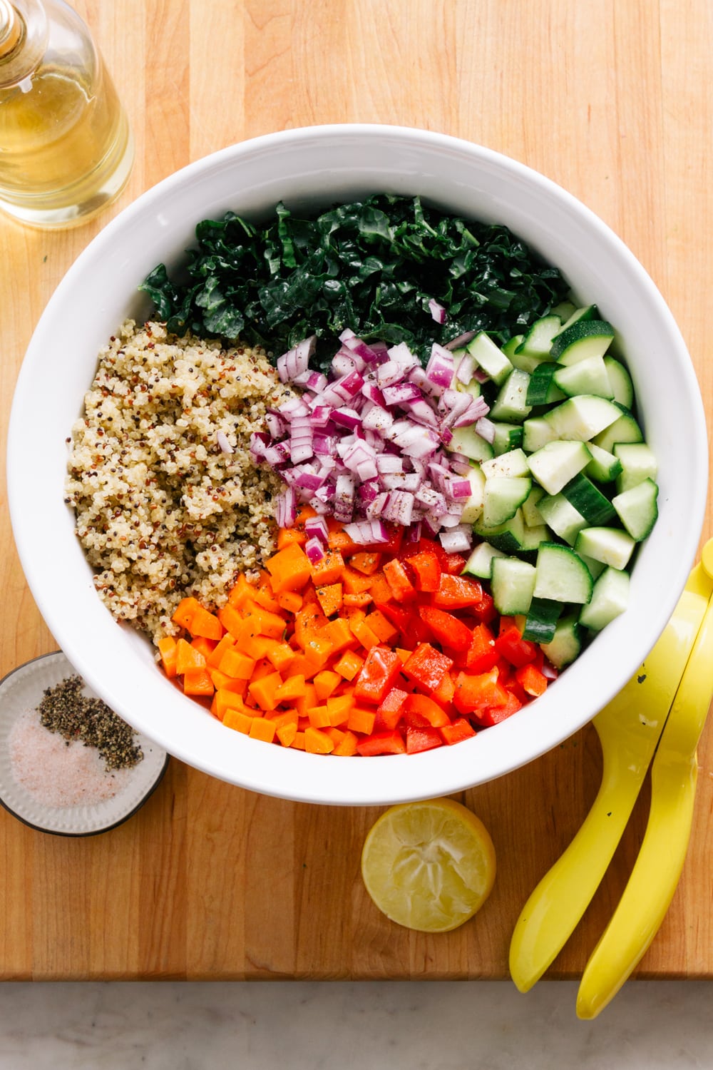 top down view of ingredients added to white bowl, sitting on a wooden cutting board.